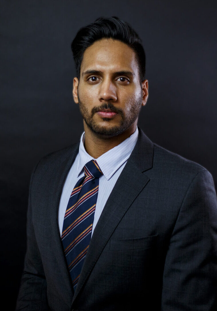 Apram Singh Apram Singh headshot on black background